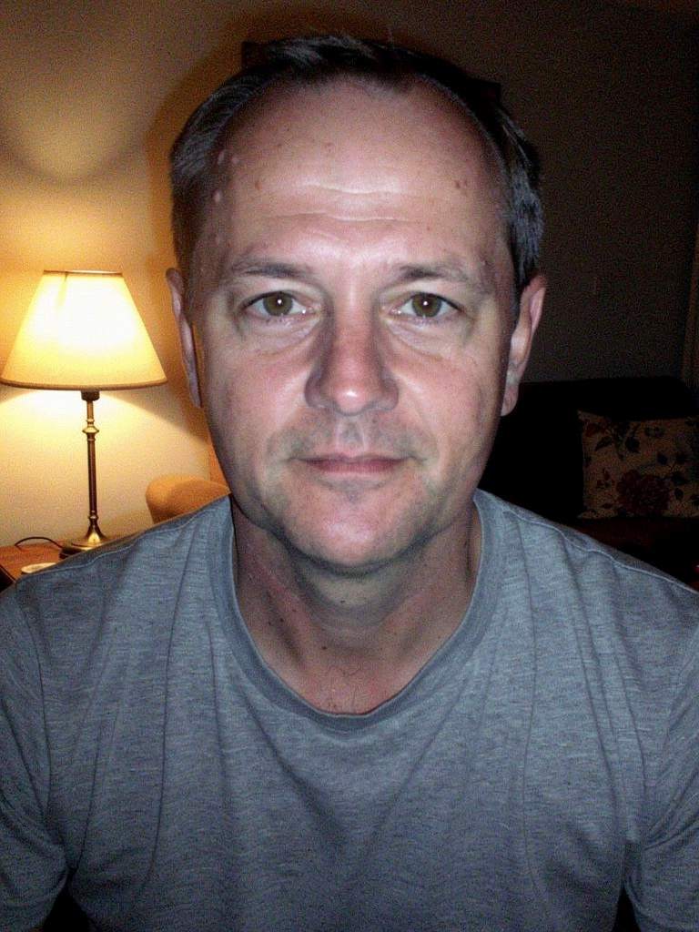 Casual before photo &mdash; an everyday snapshot of a White European man in his mid 40s (AI-generated)